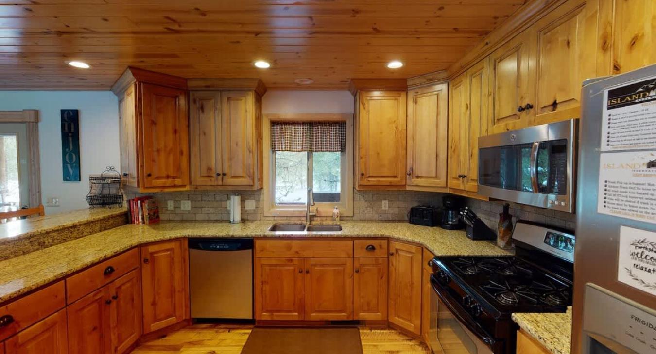 Full size kitchen with modern appliances, pots and pans, dishes, utensils, and basic cooking essentials.
