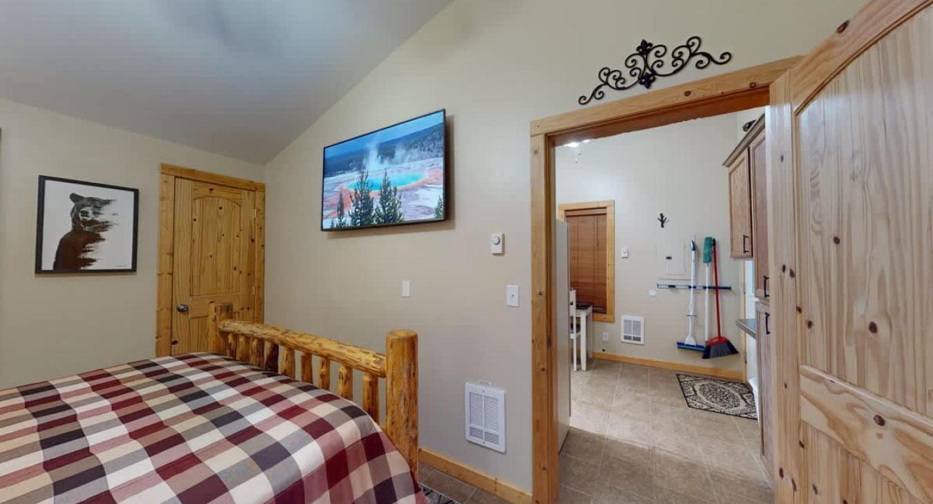 A view of the kitchen is visible from the entrance to the room.