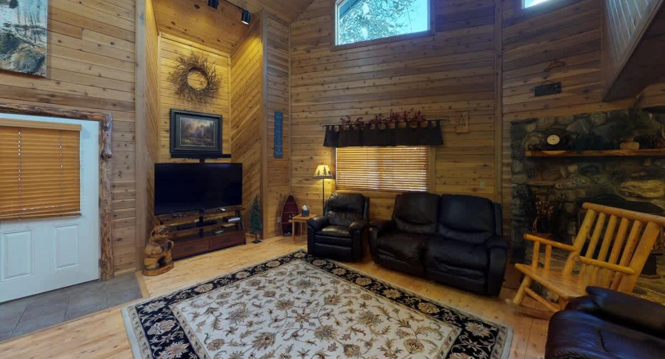 Spacious living room comes equipped with a T.V. and comfortable couches.