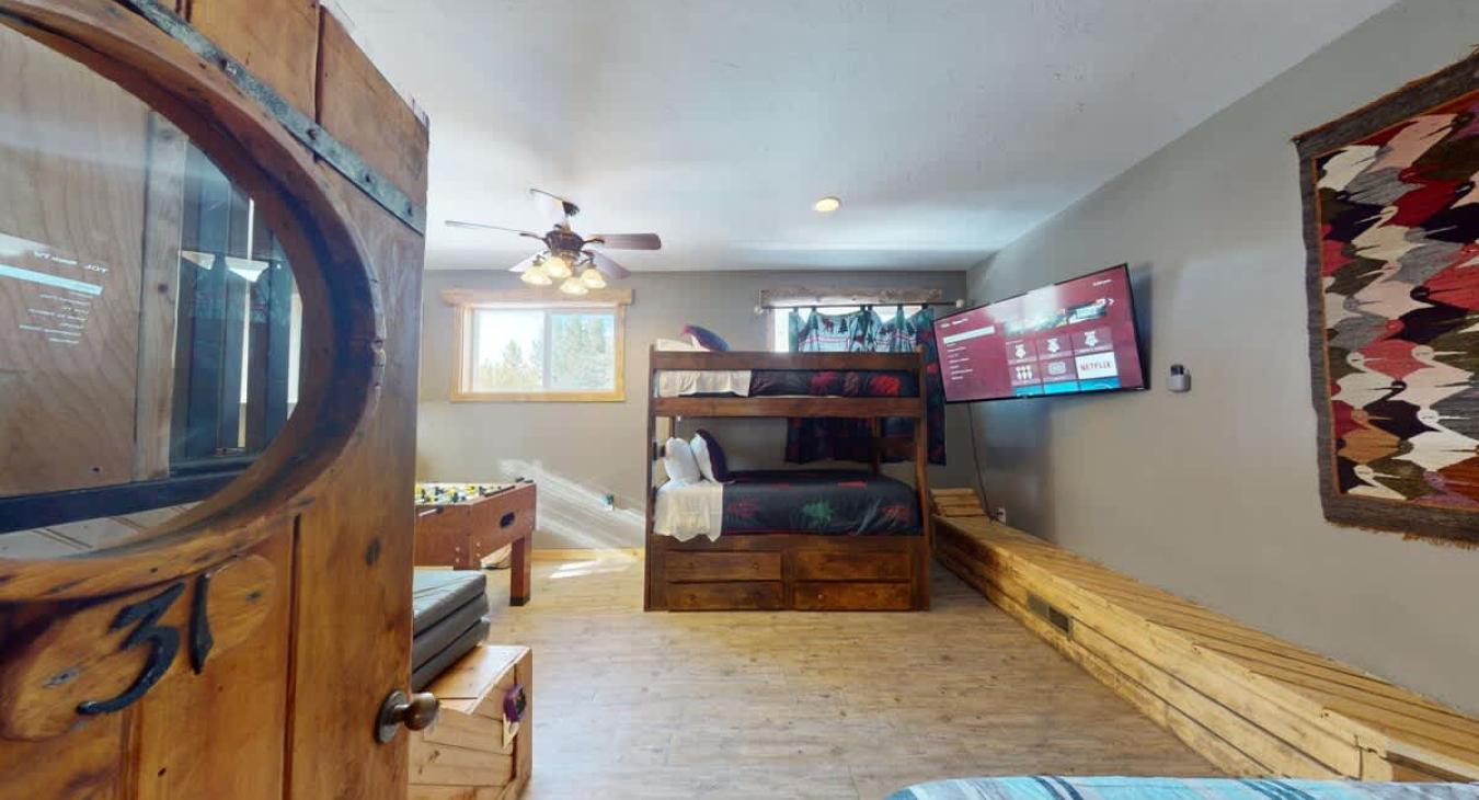 Bedroom #5 with 3 twin beds and game area.