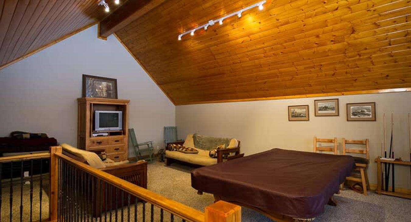 Loft space with seating and tv.