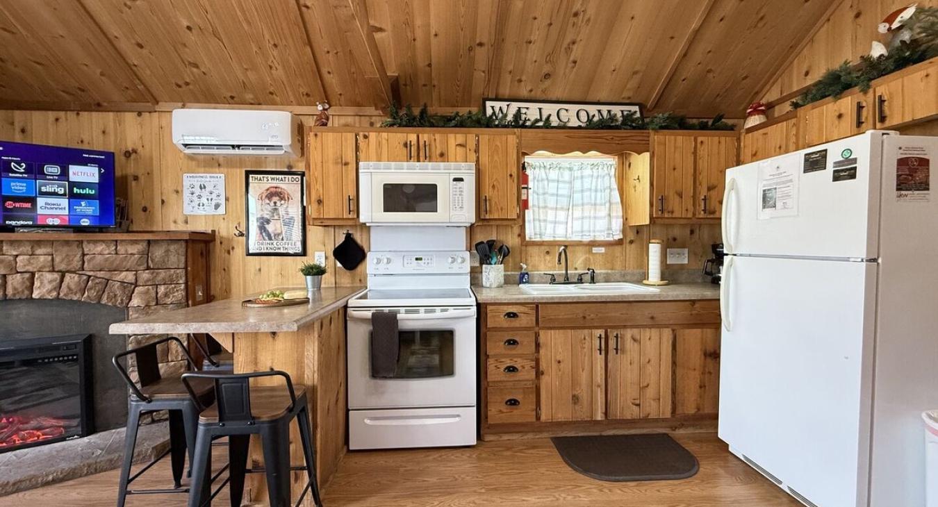 Full size kitchen with appliances, pots and pans, dishes, and cooking essentials.