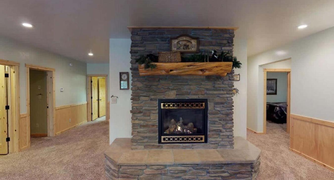 Fireplace in the basement living room to relax after a long day outdoors.