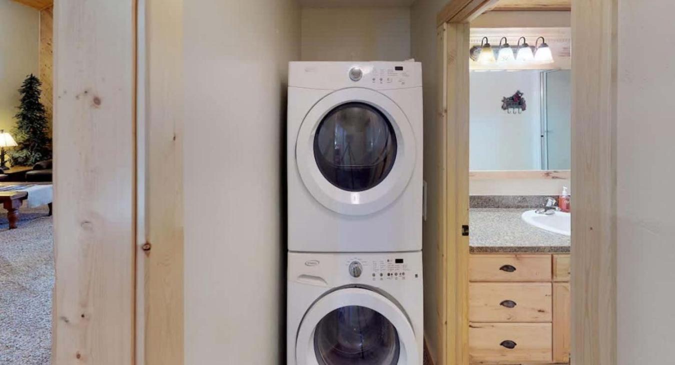 Outside of the bathroom is a stacked washer and dryer for your use. Laundry soap is provided.