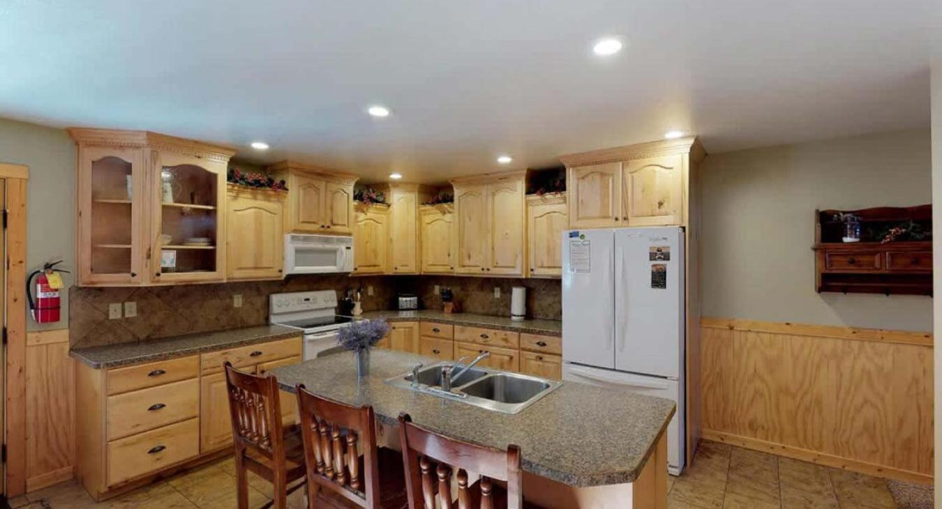 Full kitchen with appliances, cookware, dishes, utensils, and cooking essentials.