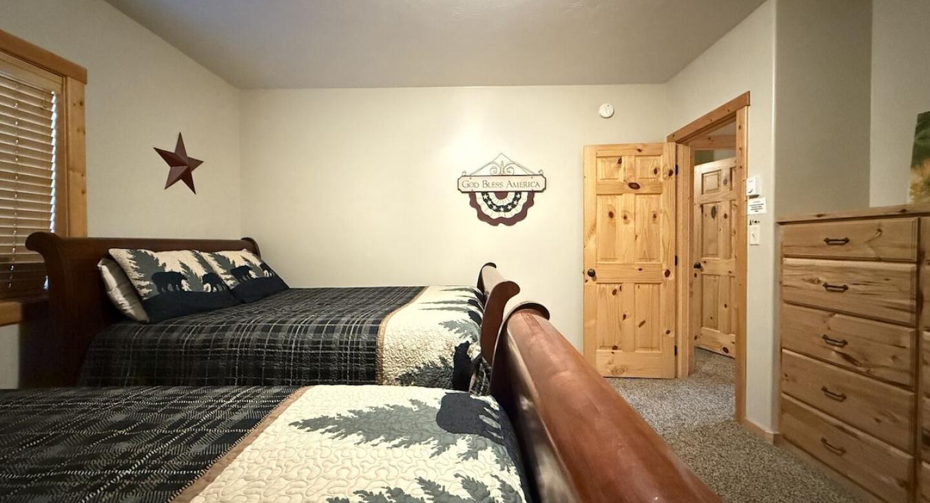 Bedroom #1 located in the basement, equipped with 2 Queen size beds.