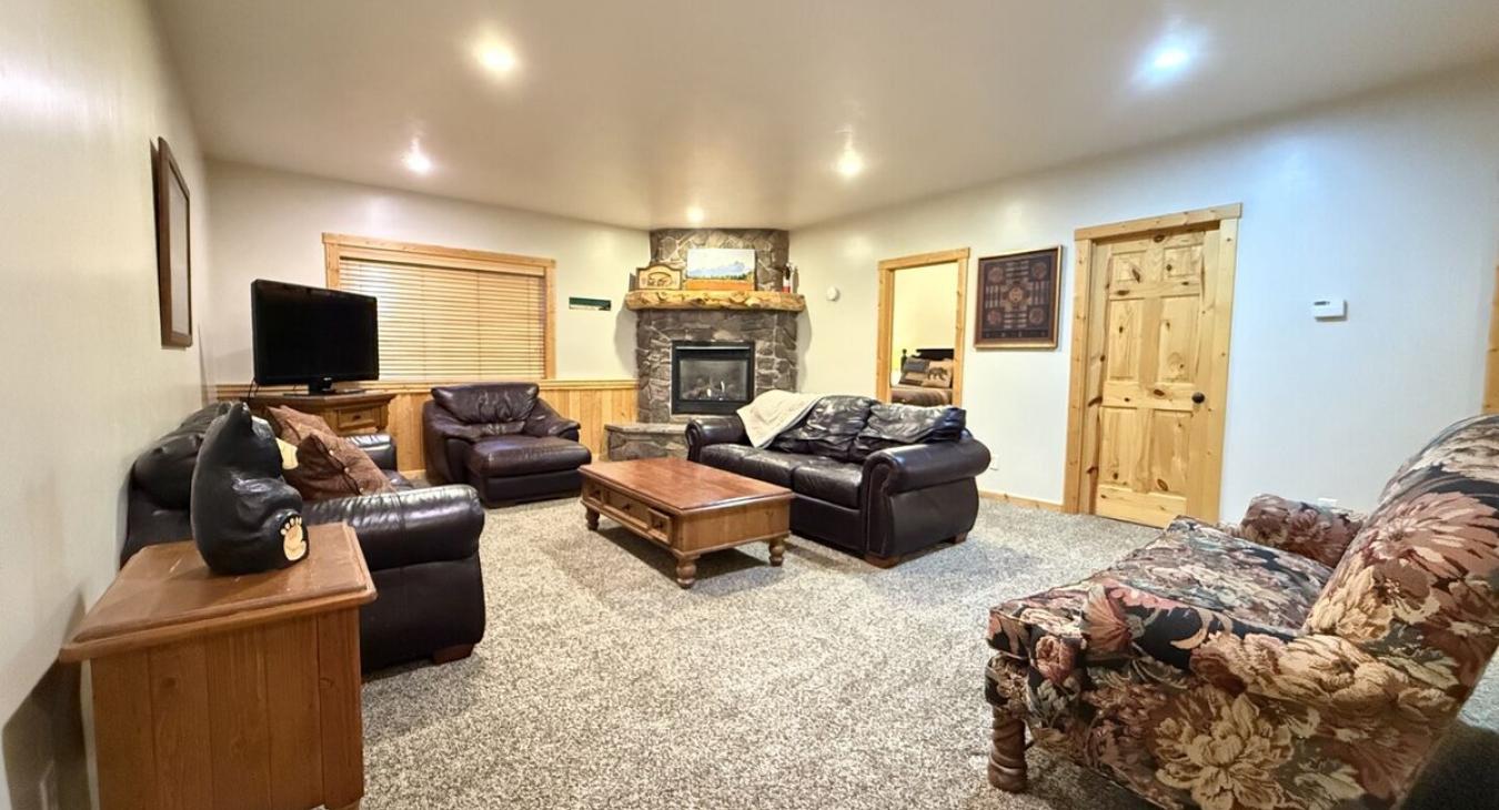 Relax after a long day in the living room that mixes both rustic charm and modern amenities.