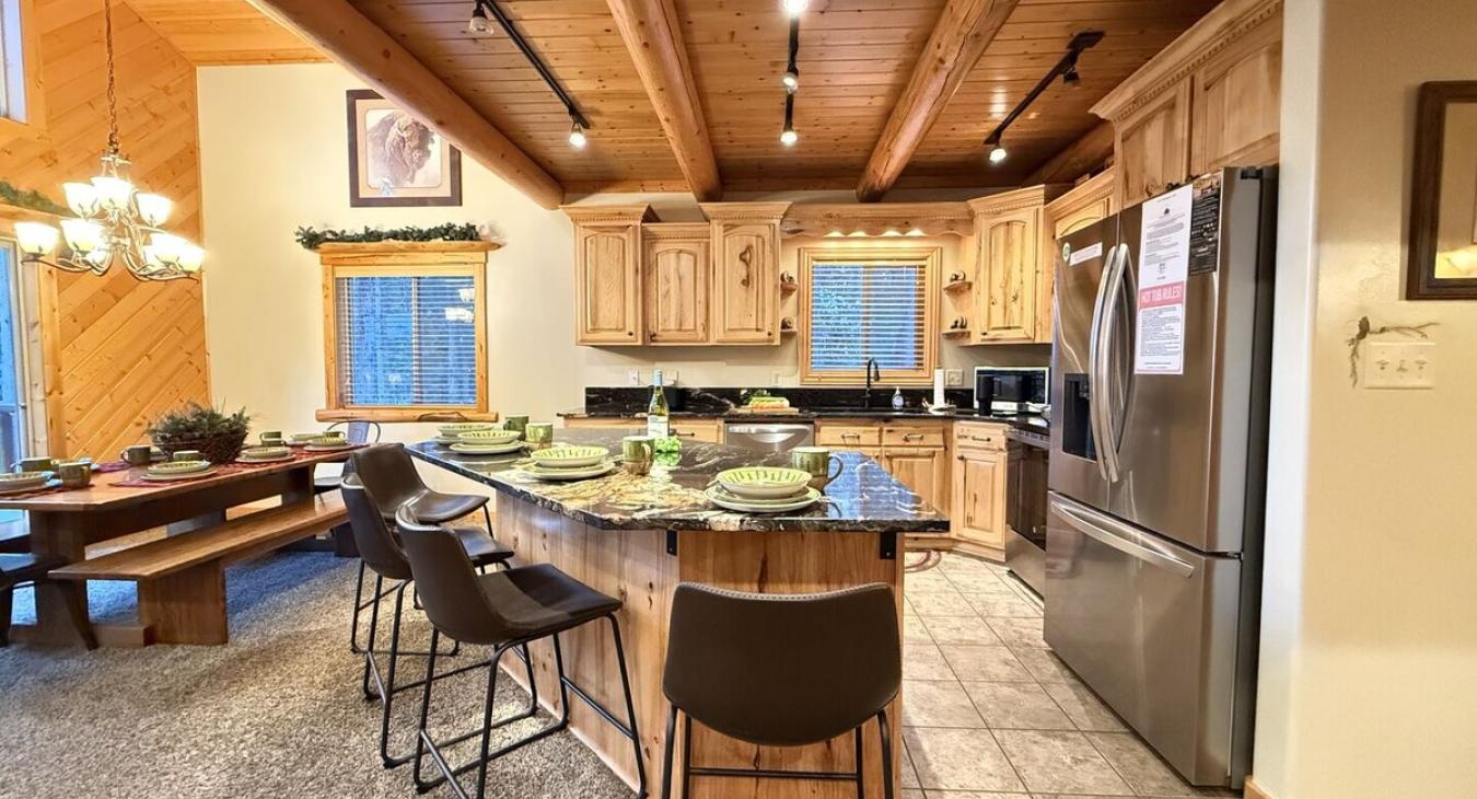 The open kitchen blends seamlessly into the cabin's cozy living area, creating a welcoming space perfect for gathering and unwinding.