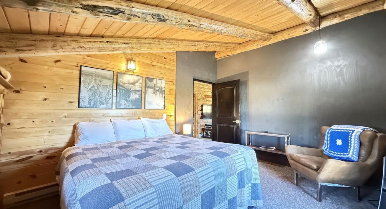 This beautiful king bedroom brings modern charm to a rustic cabin.