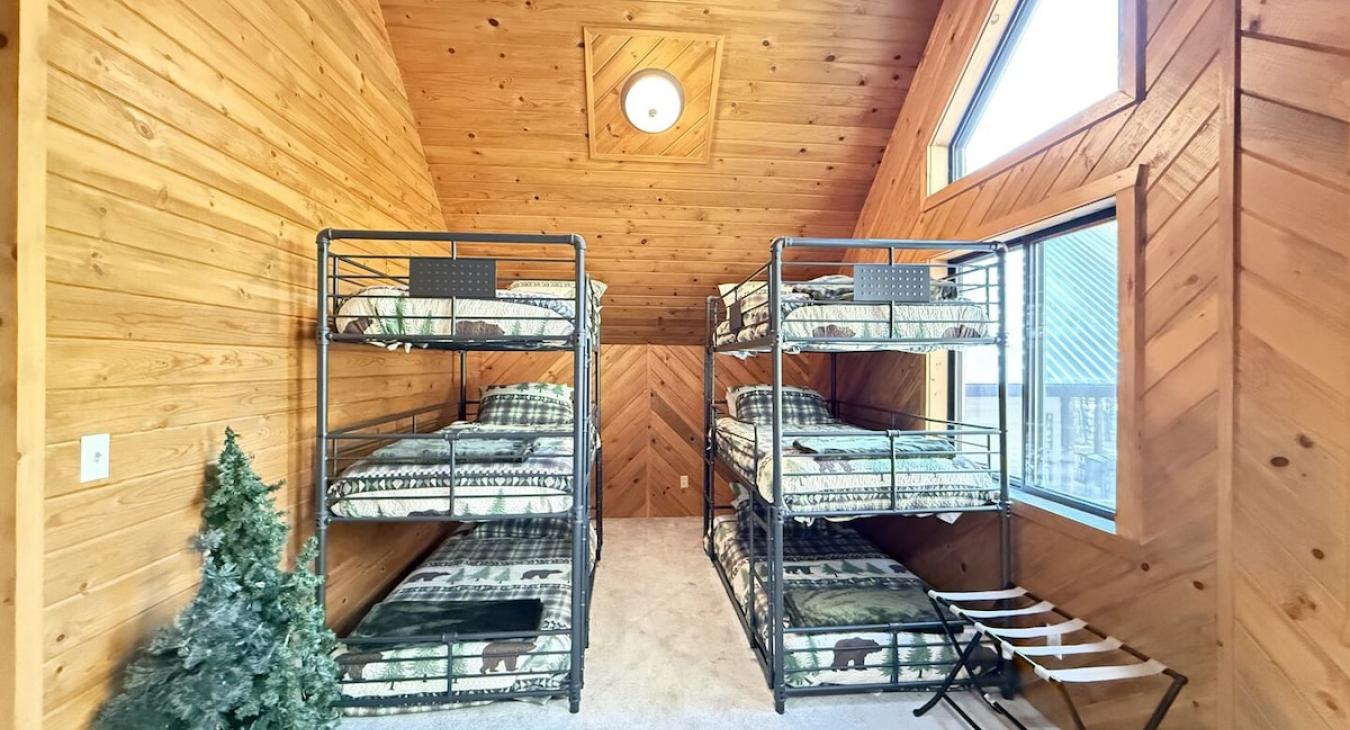 In the loft area 2 triple bunk beds. Comfortably sleeps 6 kids.