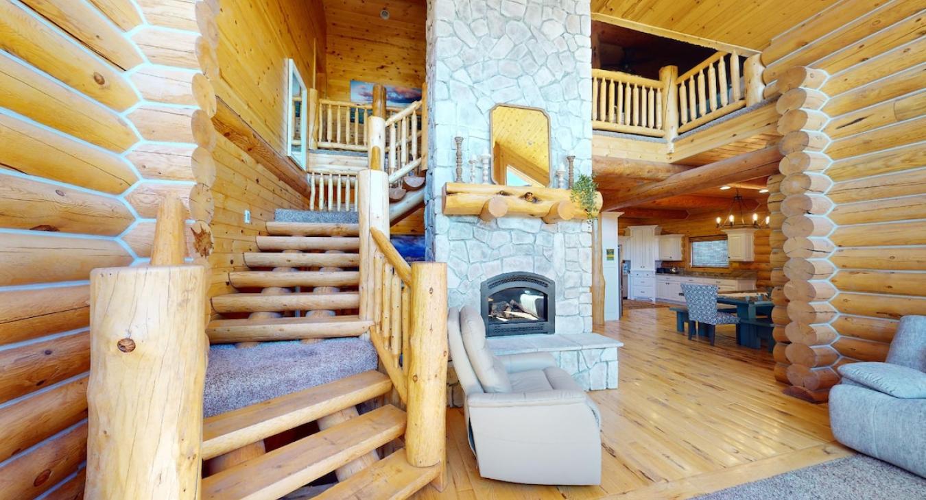 Beautiful stairs to access the second floor. Beautiful fireplace for you to enjoy, make sure to bring your own wood.