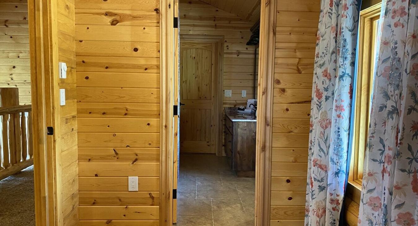 This small corner of the loft gives access to the upstairs bathroom and a small window to enjoy the beautiful landscape outside.