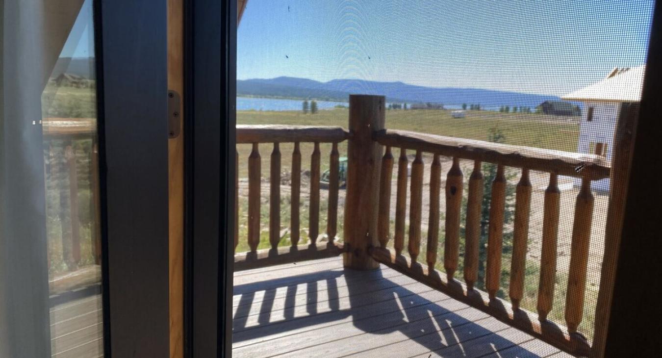 The room has easy access to a private upstairs deck through a set of French doors. The deck offers a peaceful outdoor space, where you can enjoy fresh air and take in the views of the surrounding wilderness.