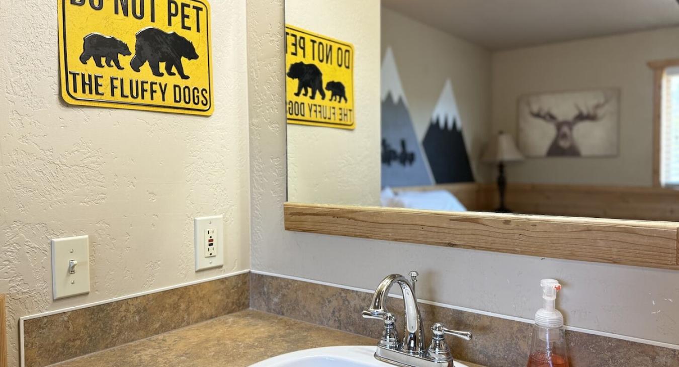 Sink and hand towel is located in this bedroom.
