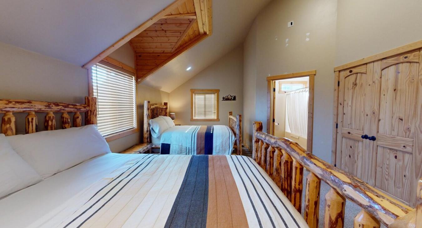 Tucked discreetly into one corner is the ensuite bathroom, accessible through a wooden frame door.