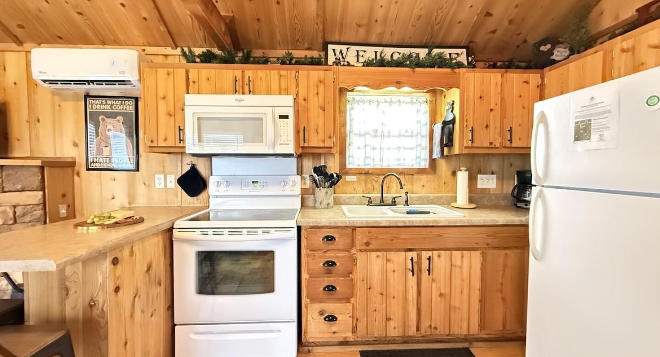 Full kitchen with appliances, cookware, dishes, silverware, and basic spices.