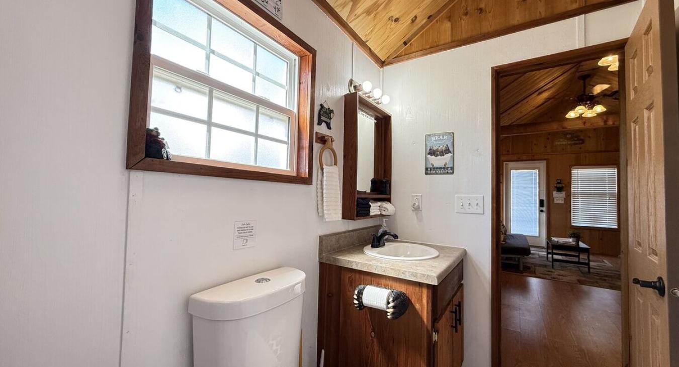 Spacious bathroom with shower/tub, toilet, and sink vantiy.