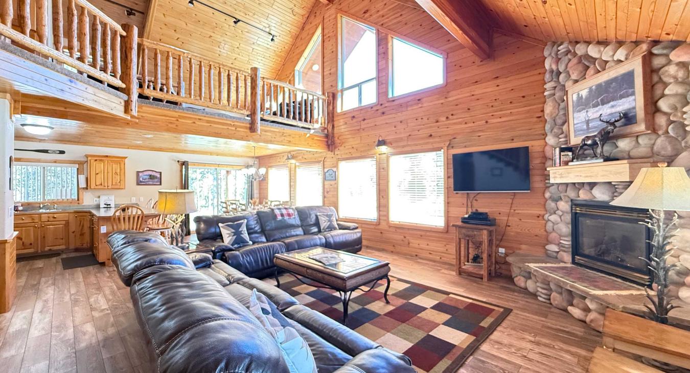 The open kitchen blends seamlessly into the cabin's cozy living area, creating a welcoming space perfect for gathering and unwinding.