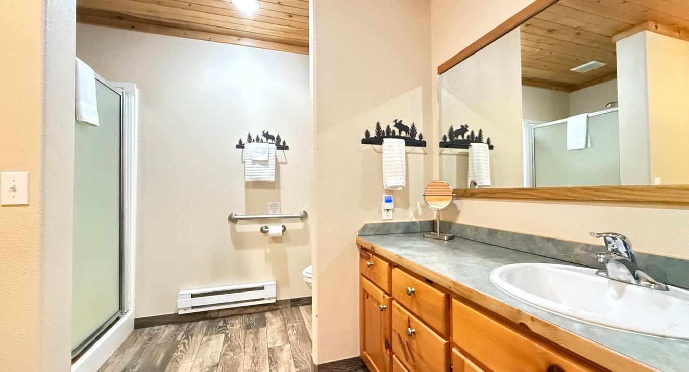Ensuite bathroom with soaking tub, standing shower, toilet, and sink vanity.