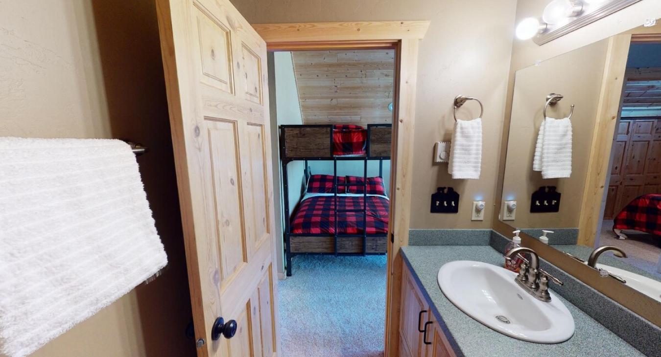 Bathroom is equipped with shower tub combo, toilet, and sink vanity.