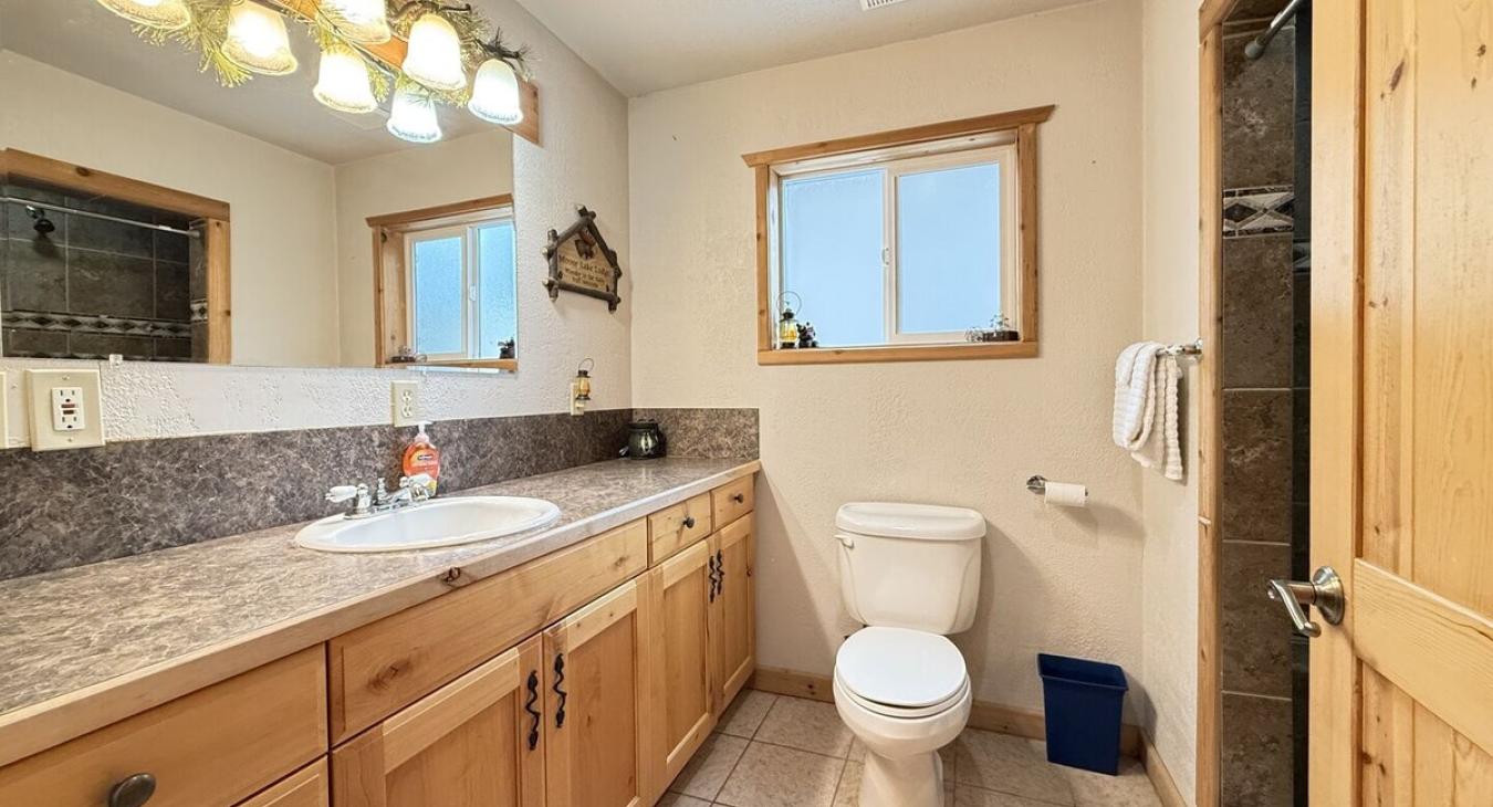 Main level shared bathroom has a deluxe walk-in shower.
