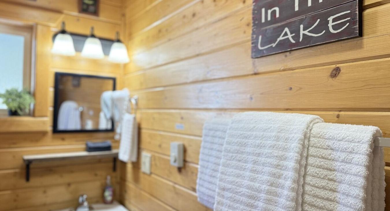 The second bathroom is equipped with a standing shower, sink, and a toilet.
