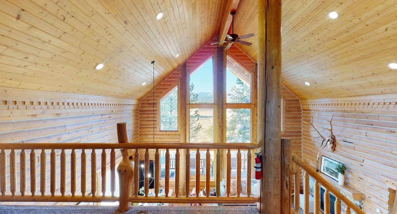 Upstairs loft area with natural light from the windows.