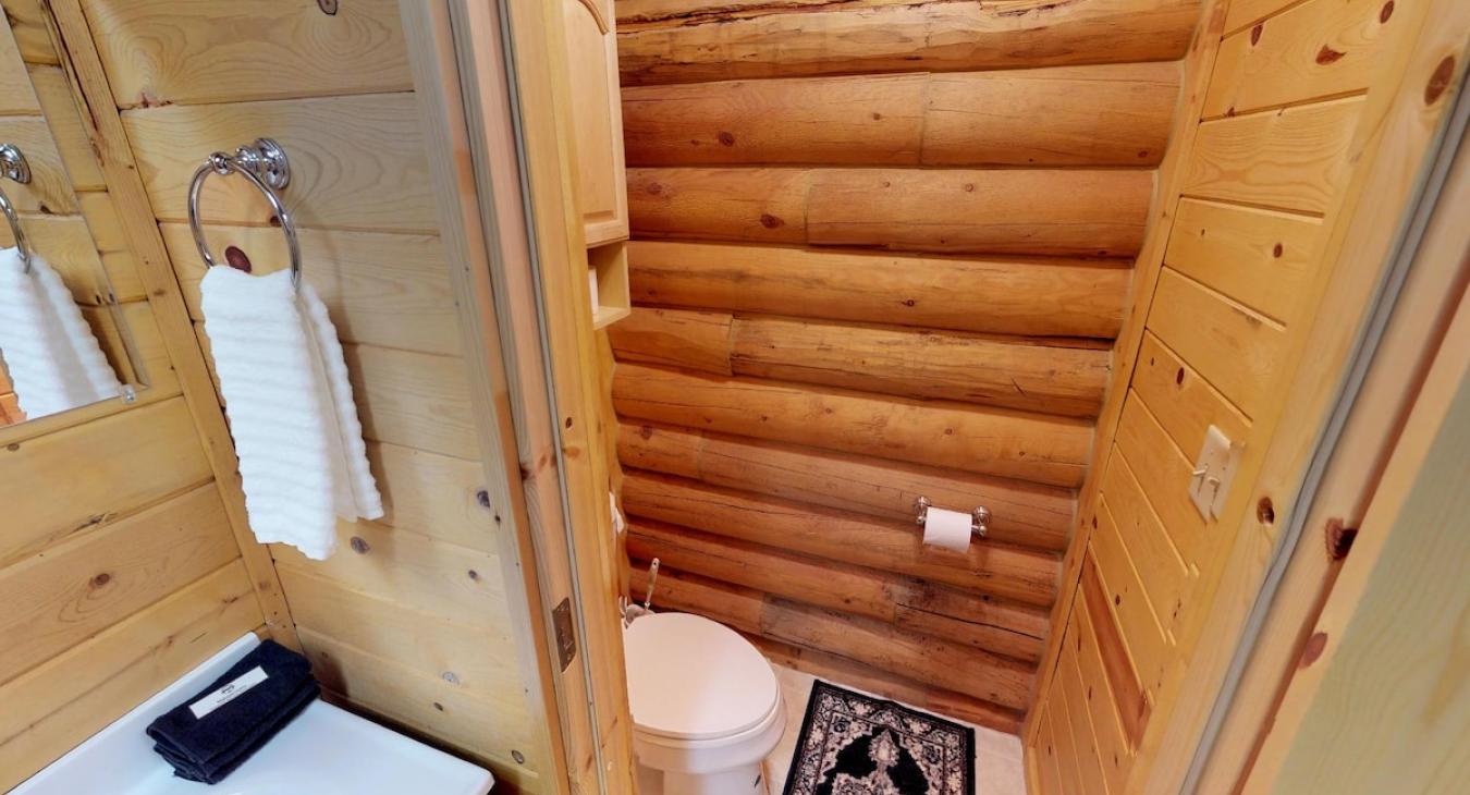 Half bathroom on the main floor with a toilet and sink vanity.