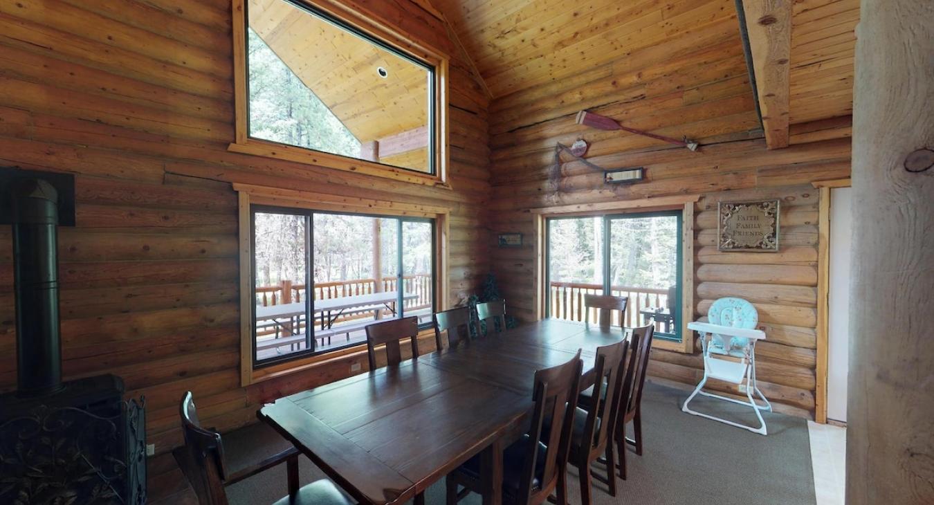 Large dining table that seats 8 with additional seating at the kitchen island.