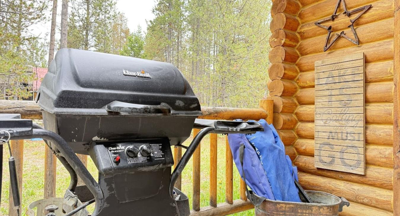A propane grill on the front porch.