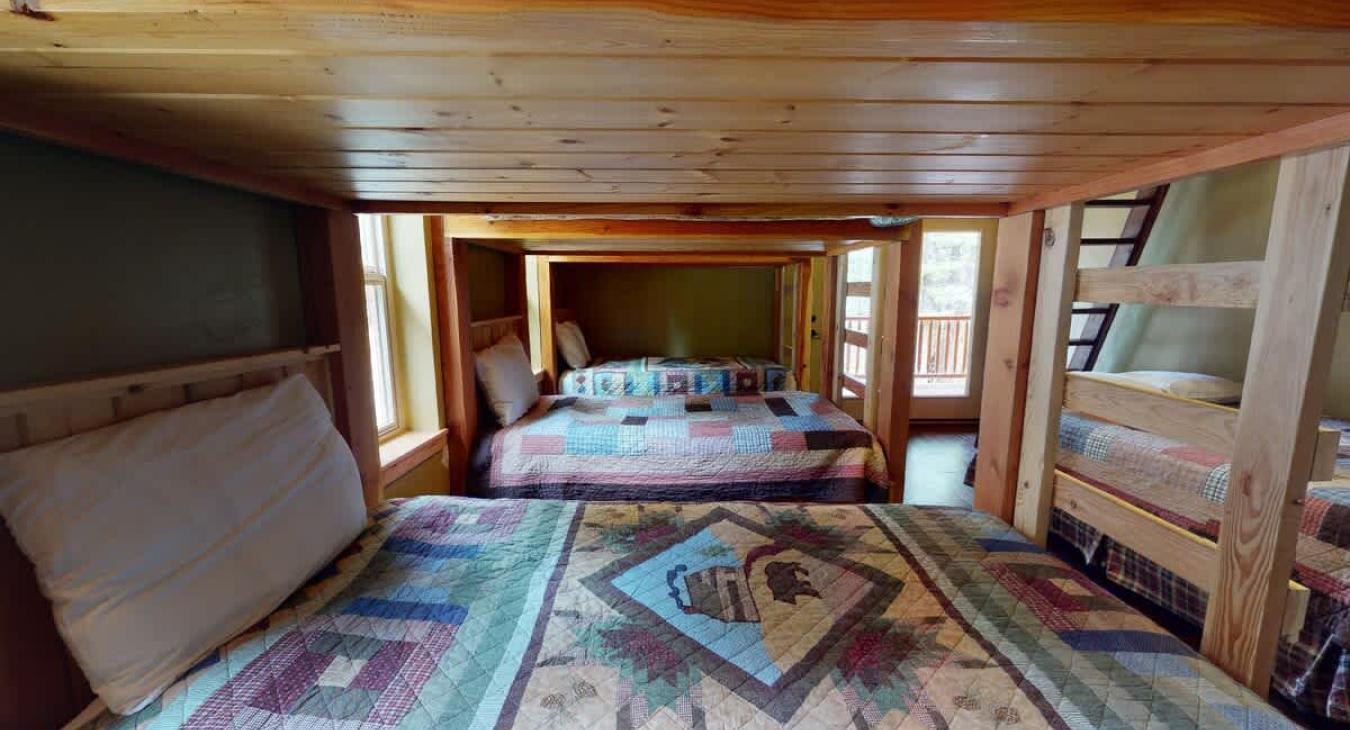 Bedroom #3 located upstairs with  6 twins and 1 Queen bed.