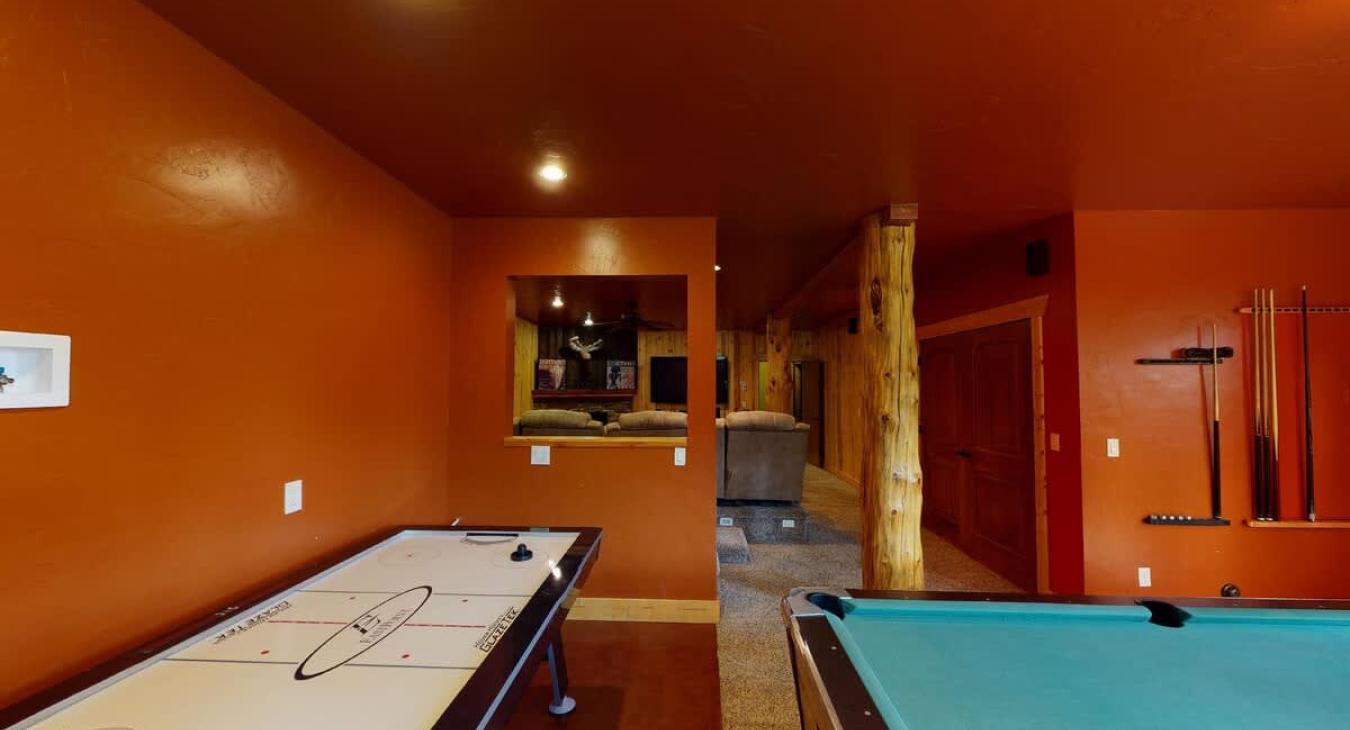 Open concept game room that leads to the basement living room.