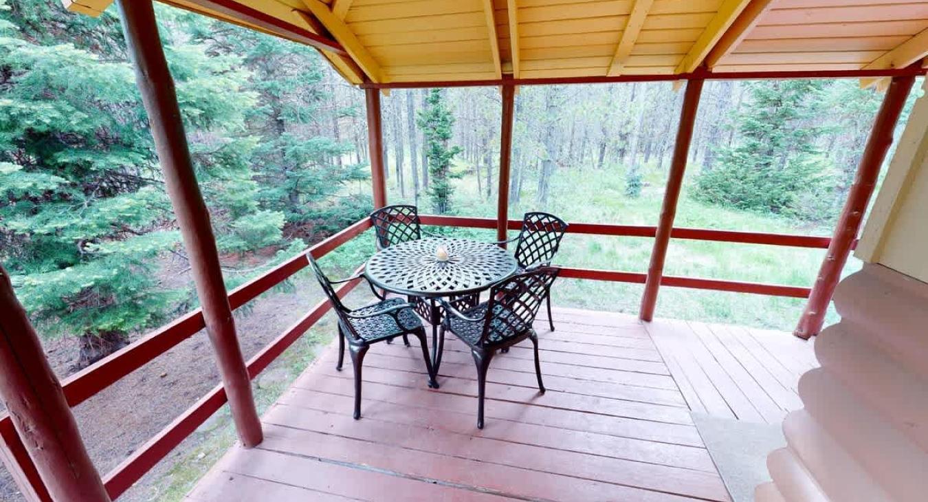 Outside is a deck with a table to enjoy the scenery outside.