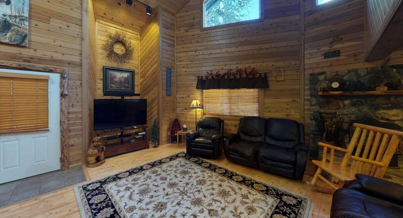 Spacious living room comes equipped with a T.V. and comfortable couches.