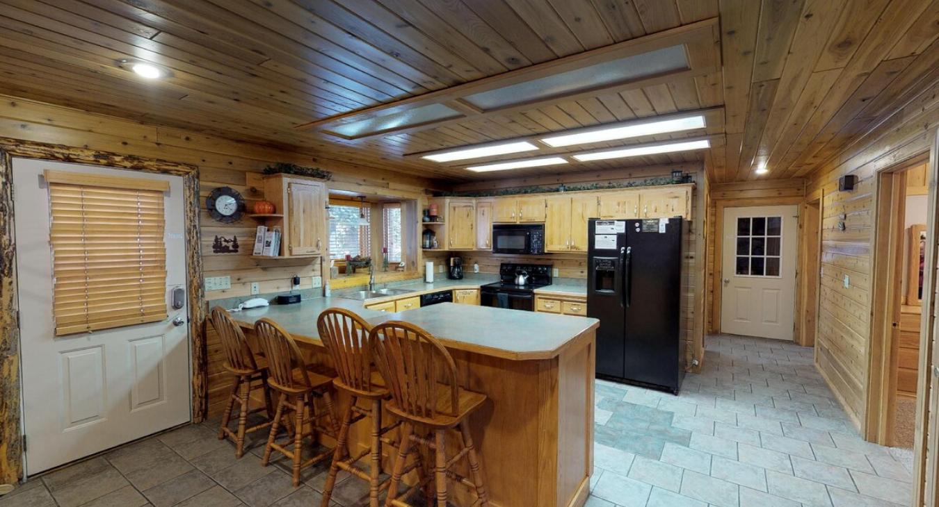 Kitchen has bar for added seating and counter space.