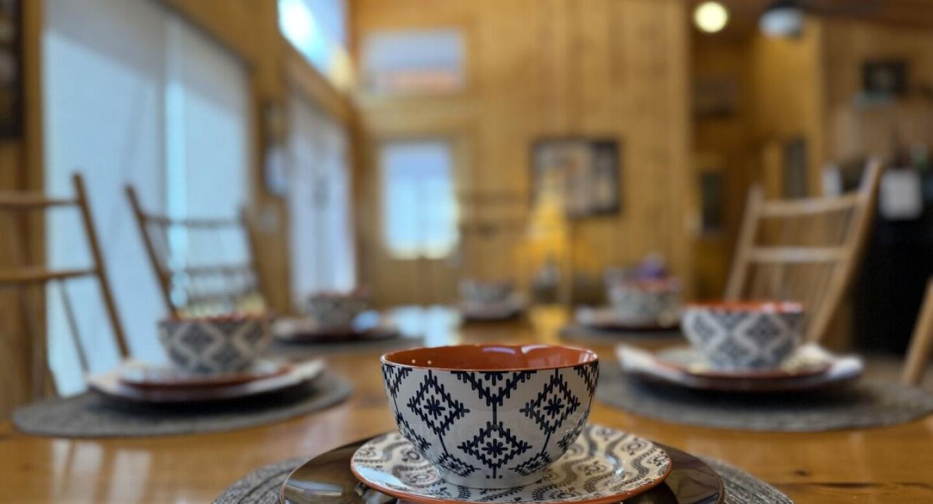 Large dining table with full place settings.