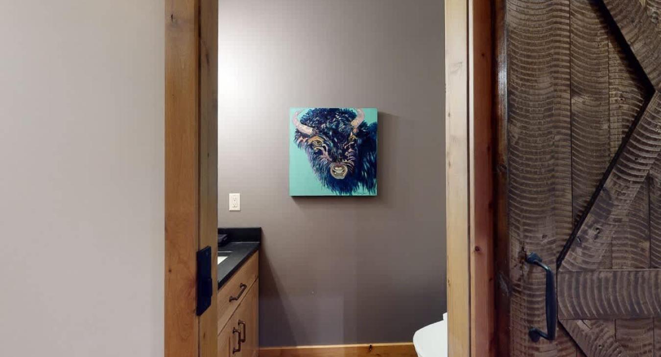 The half bathroom accessible via the hallway.