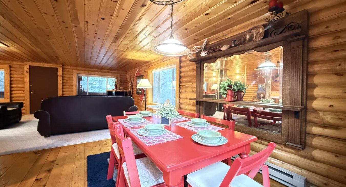 Dining room table with 6 seats and additional chairs.
