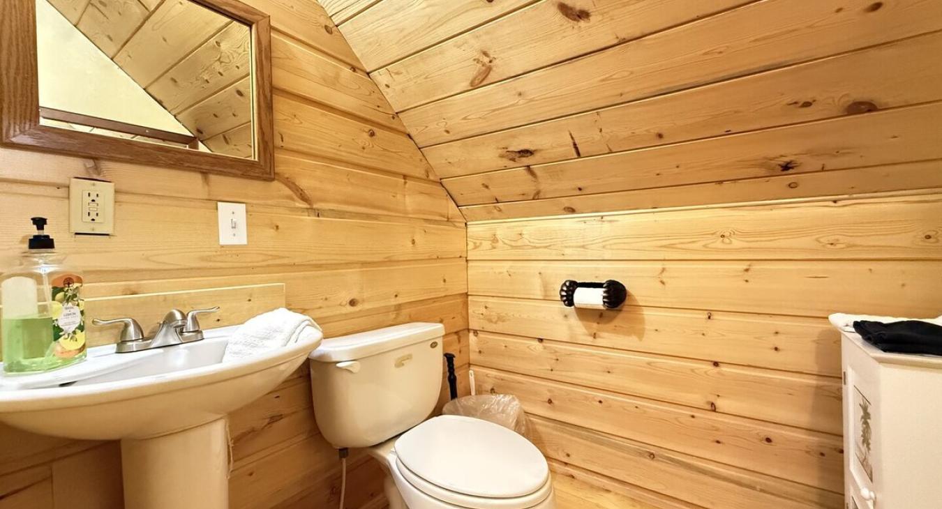 Upstairs half bathroom with toilet and sink.
