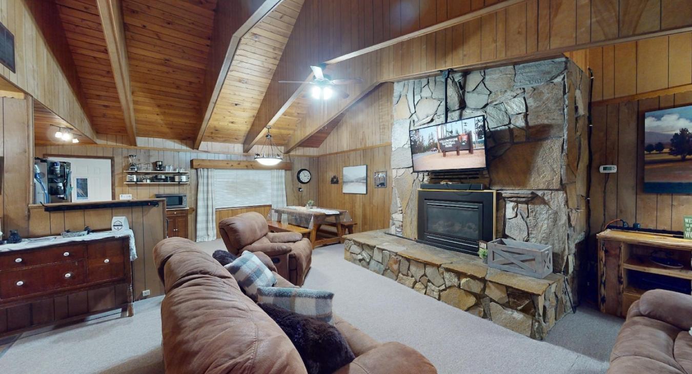 Beautiful living room with a fireplace and seating. Make sure to bring your own wood.