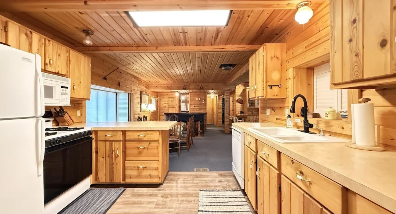 Kitchen includes appliances, cookware, dishes, silverware, and basic spices.