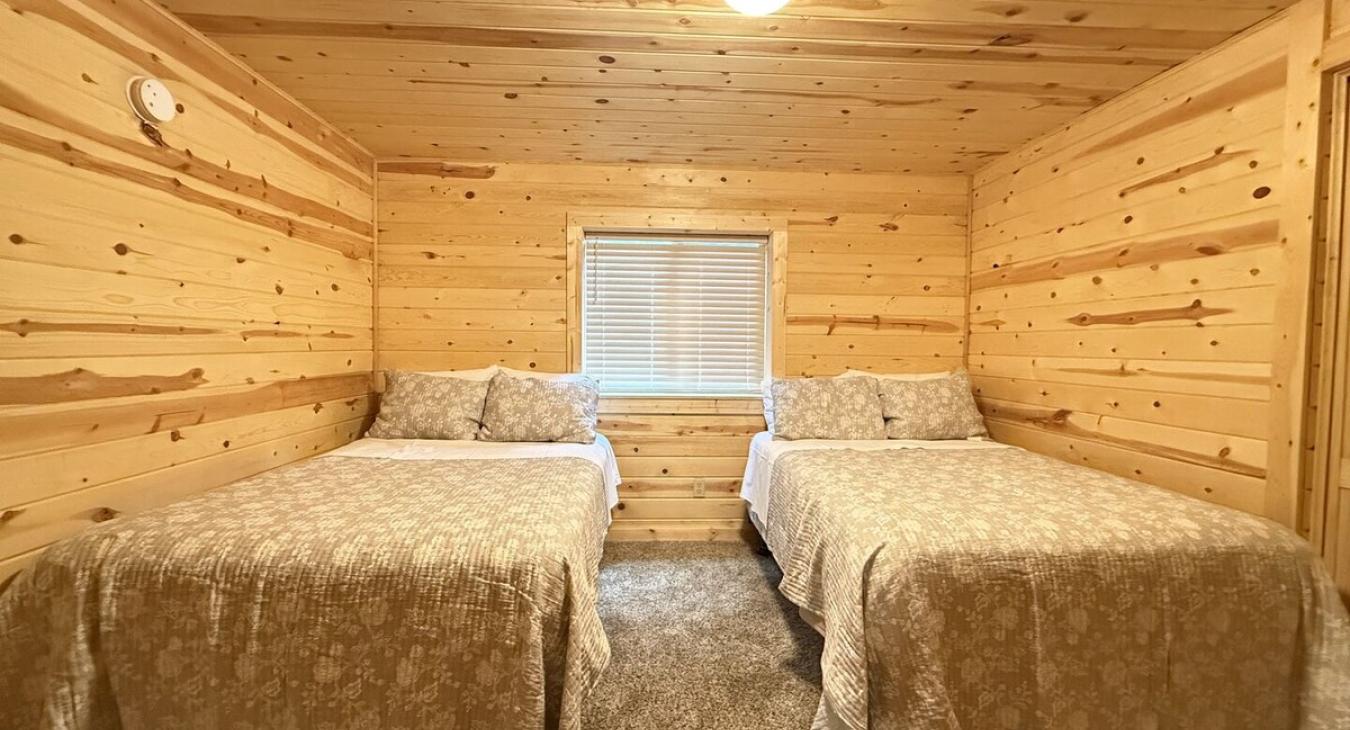 Bedroom #5 located downstairs with two Double beds.