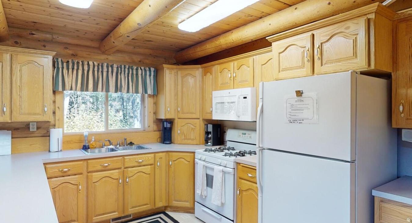 Kitchen equipped with appliances, pots and pans, dishes, utensils, and basic cooking essentials.