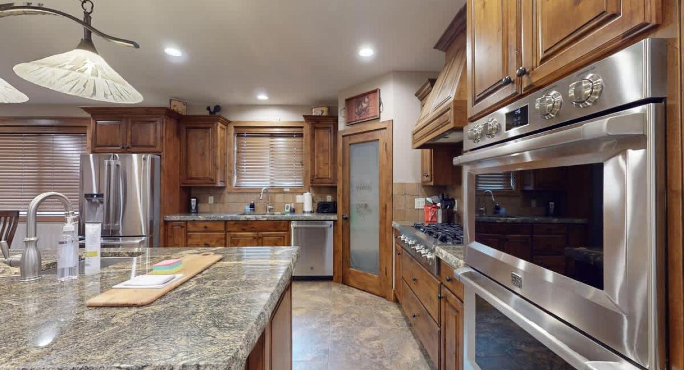 Equipped with stainless steel appliances, dishes, silverware, pots and pans, and basic cooking essentials.