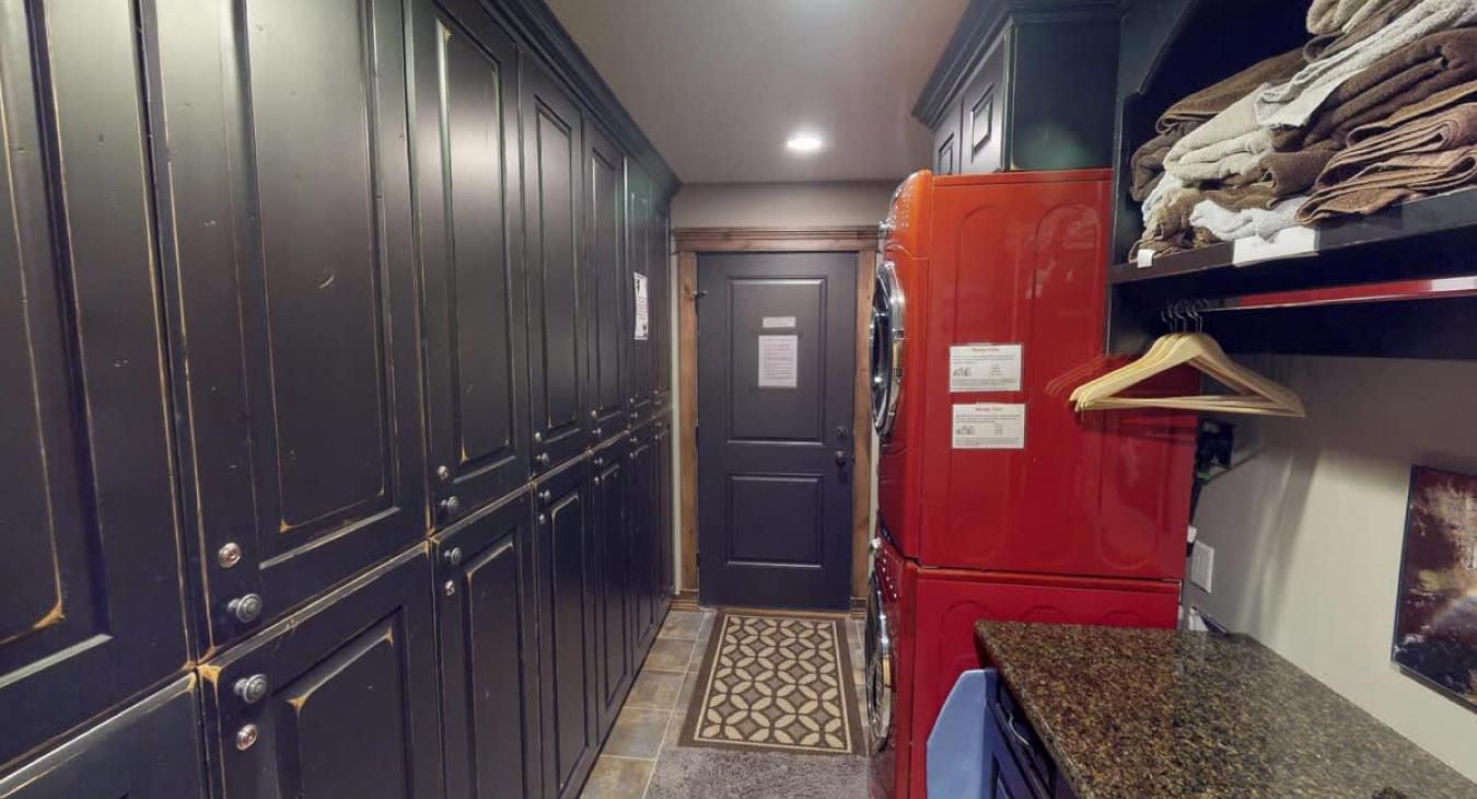 Mud room with full size stacked washer and dryer.
