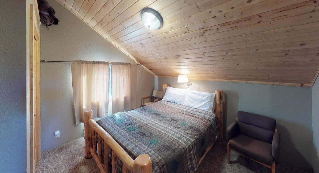 Bedroom #3 located upstairs with a Queen size bed.