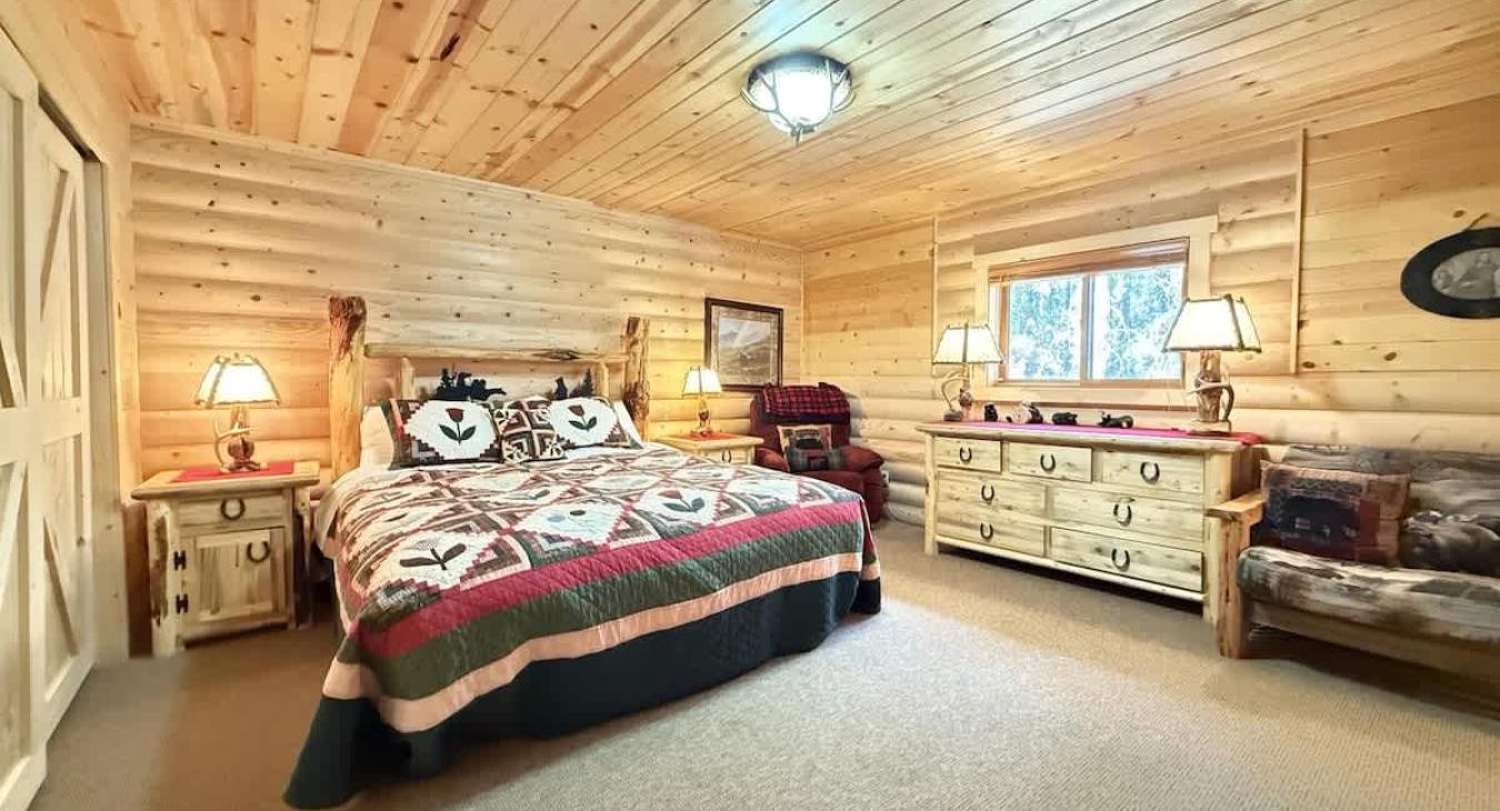 Large Master bedroom with king bed and chair for reading a book