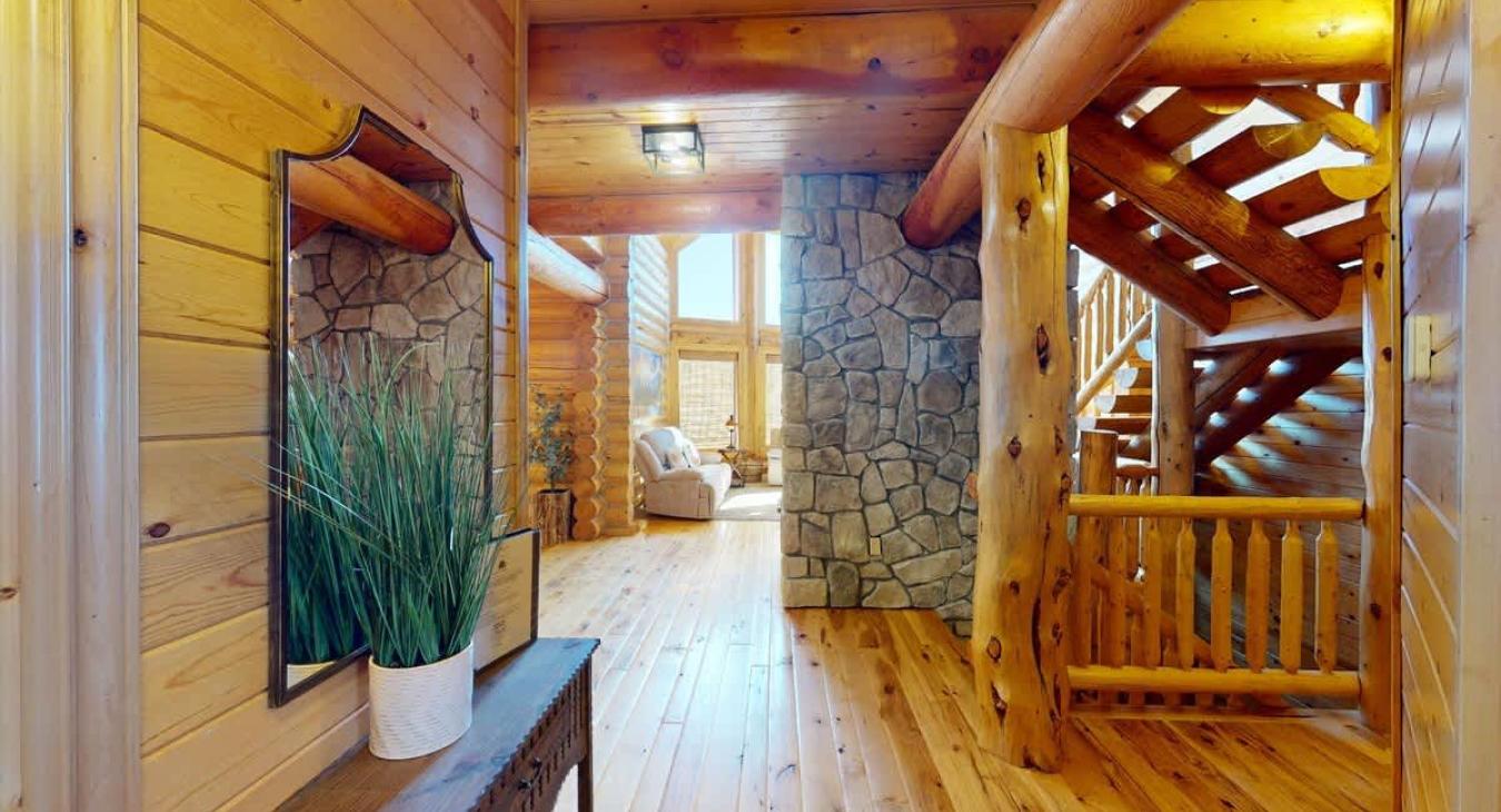 The hallway on the main level of the cabin is a warm, open space that flows naturally between key areas of the home. The hallway itself feels like a central point where the different areas of the cabin meet, yet it’s never too busy or cramped.