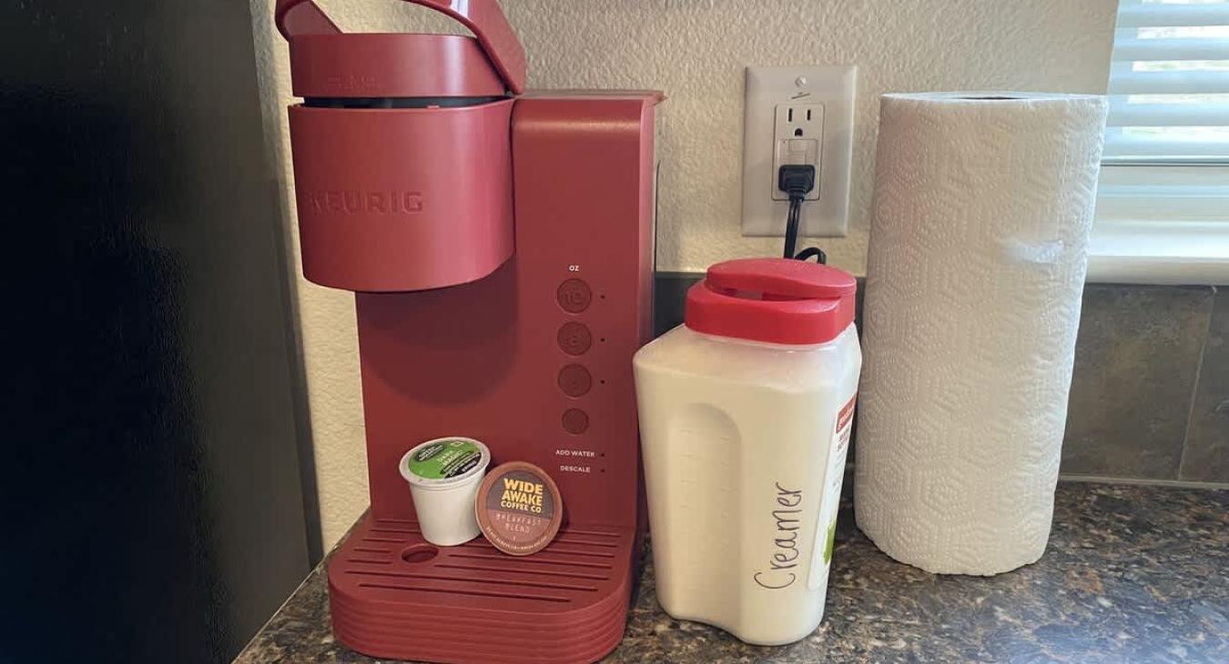 Coffee maker with pods located in the kitchen.