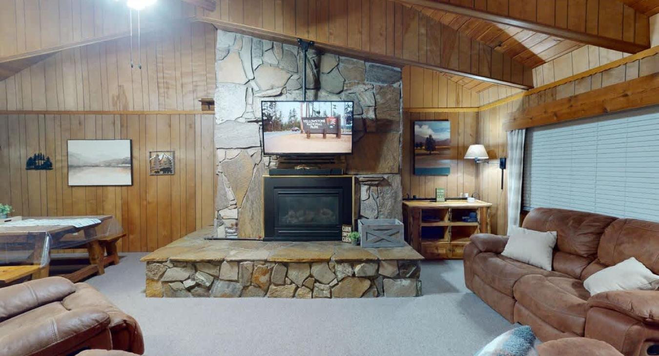 Beautiful living room with a fireplace and seating. Make sure to bring your own wood.